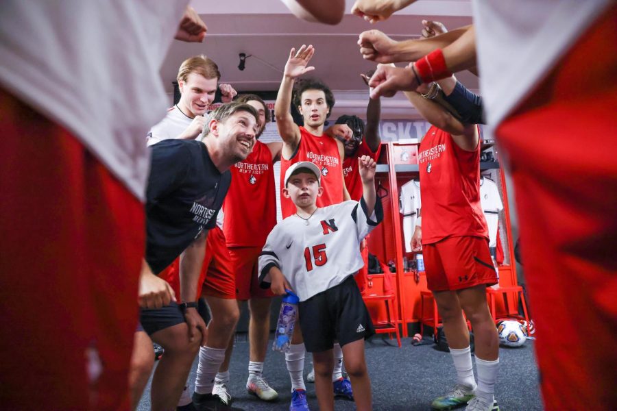Lincoln Mosca, the youngest member of the Northeastern men’s soccer team, participates in the team’s pre-game pep talk. Mosca partnered with the team through Team Impact.