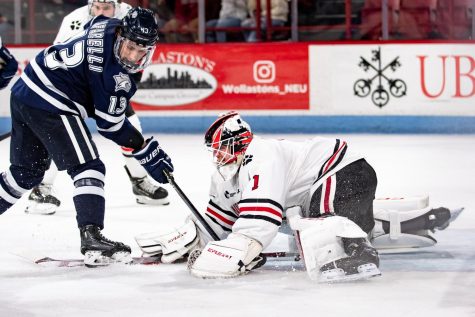 Junior goaltender Devon Levi lunges to make a save against the UNH Wildcats. This weekend, Levi broke the program’s career shutout record with 12 shutouts in 41 games.