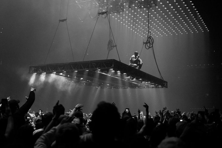Kanye West performing at TD Garden Sept. 9, 2016 in Boston on the Saint Pablo Tour. Kanye West Saint Pablo Tour TD Garden 2016 5 by Kenny Sun is licensed under CC BY 2.0.