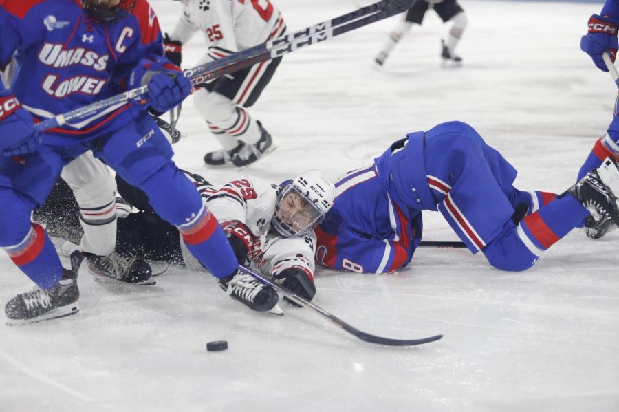Sophomore forward Justin Hryckowian fights to steal the puck from UMass Lowell Oct. 22. Hryckowian won 14 of his 23 faceoffs against the River Hawks that night.