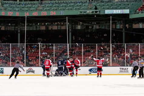 The Northeastern Huskies celebrate during a game at Fenway Park. The team won the Frozen Fenway matchup 4-1 over the University of Connecticut.