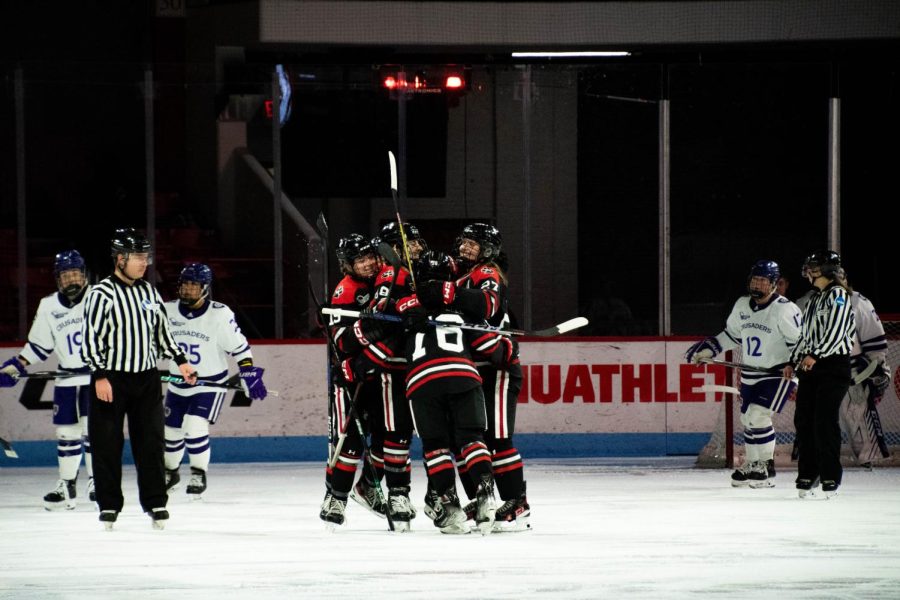 The+Huskies+celebrate+a+goal+against+the+Crusaders+Friday+night.+Northeasterns+4-0+win+secured+a+fourth+consecutive+Hockey+East+title+for+the+team.