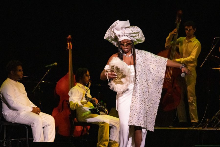 Orji holds a fan and a microphone while performing “Eberechukwu’s Biafra” at Berklee Performance Center Jan. 31. The “Visionaries Collective” was formed organically while Orji worked on the project.