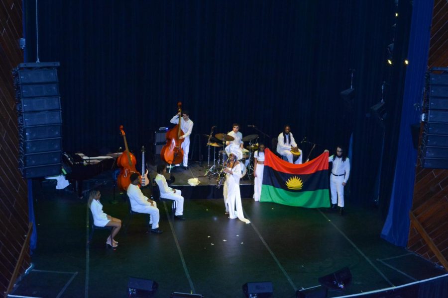 Orji plays the saxophone in front of the Biafran flag during the performance of “Eberechukwu’s Biafra.” Orji acknowledged this song as a tribute to her ancestors and heritage.