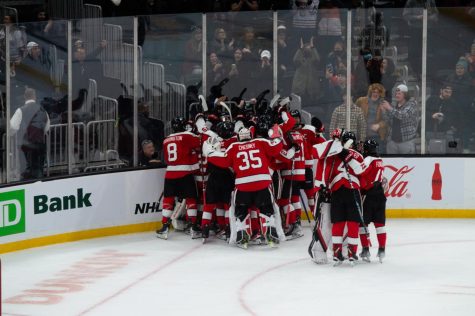 The Huskies pile on junior goalie Devon Levi after Monday nights game. With the win, Northeastern will head to the title game against Harvard Monday, Feb. 13.