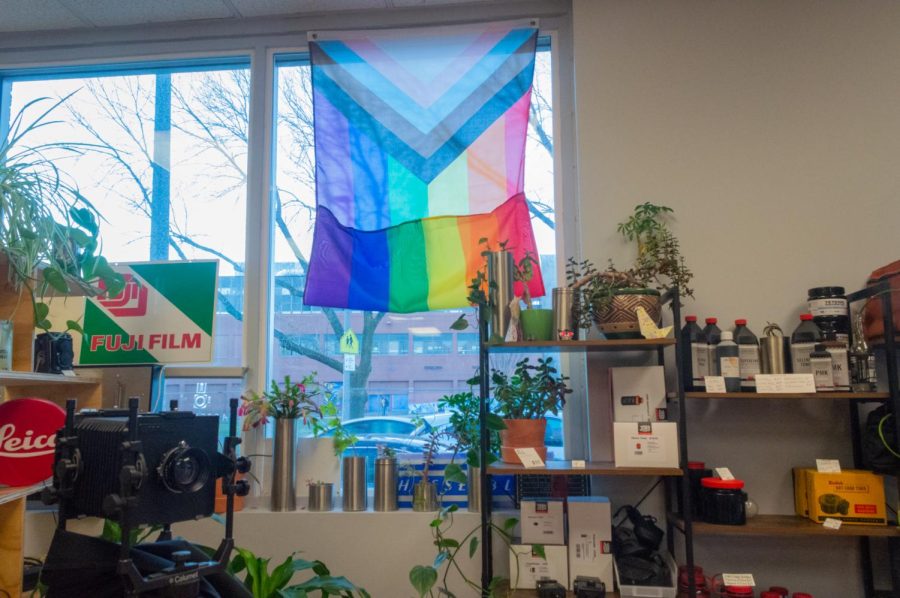 A pride flag hangs in the window of CatLABS in Jamaica Plain. The photography store offers a unique gender-pay-gap discount.