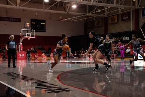 Graduate student guard JaMiya Braxton dribbles the ball up the court. Braxton tallied a career-high 22 points in Friday nights game. 