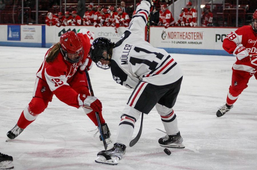 Graduate student forward Alina Müller battles for the puck on a faceoff. Müller, who holds Hockey Easts all-time scoring record with 168 points, will graduate from the program this spring after five years as a Husky.