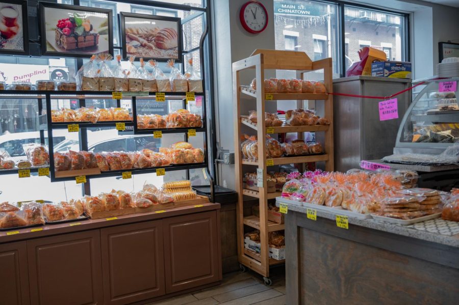 The inside contains multiple self-serve shelves of both sweet and savory pastries including walnut cookies, mooncakes and pork floss buns. The bakery placed trays and individual pastry bags by the door for customers to grab as they enter.