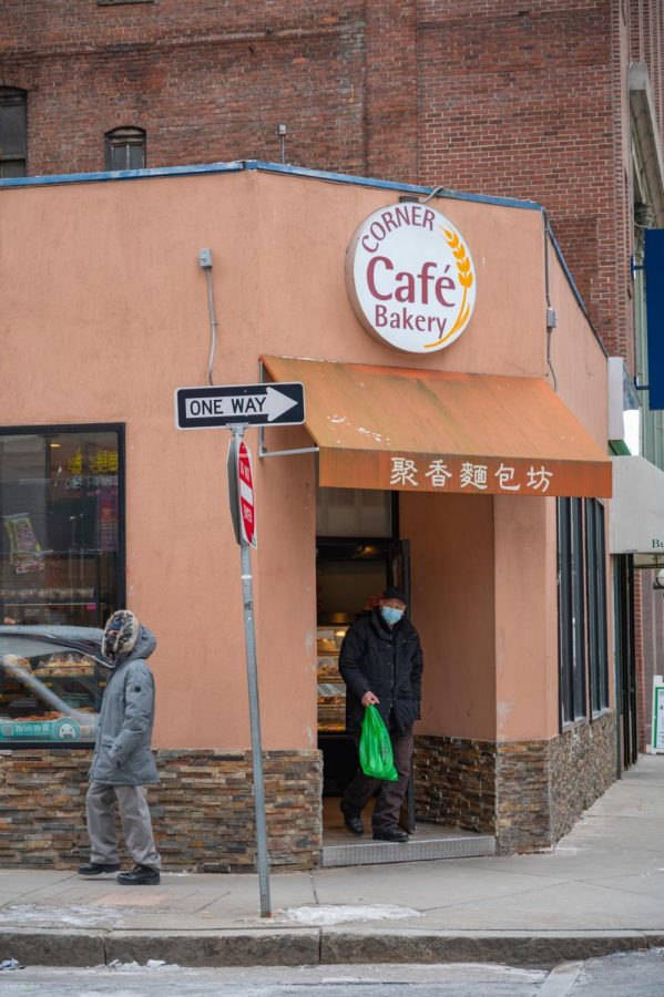 Customers exit the aptly-named Corner Café Bakery on the corner of Harrison Ave and Beach Street. The store became a staple in Chinatown for their delicious pineapple buns and large selection of mooncakes.