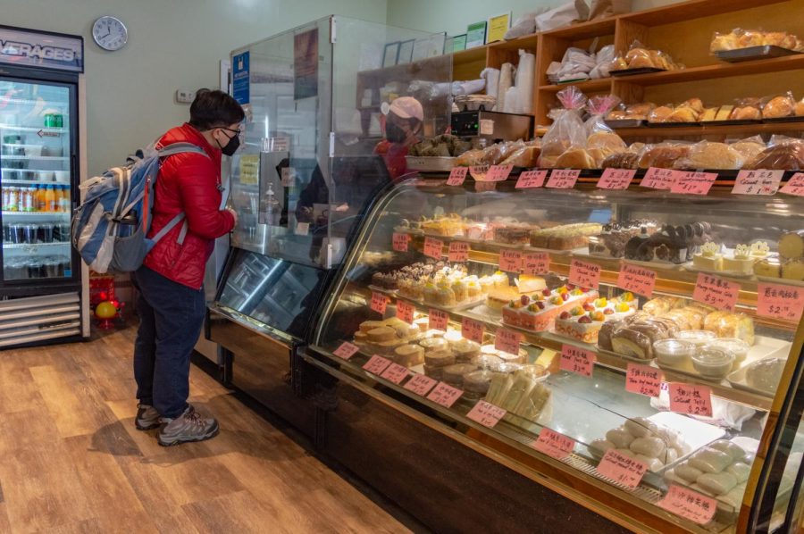 A customer orders treats at Great Taste Bakery. The store offered a variety of baked goods such as fruit cakes, cream rolls and cupcakes decorated to look like mice.