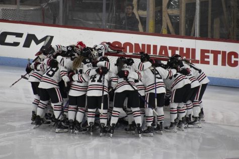 The Northeastern womens hockey team huddles before a game. They currently hold a 33-2-1 record this season. 