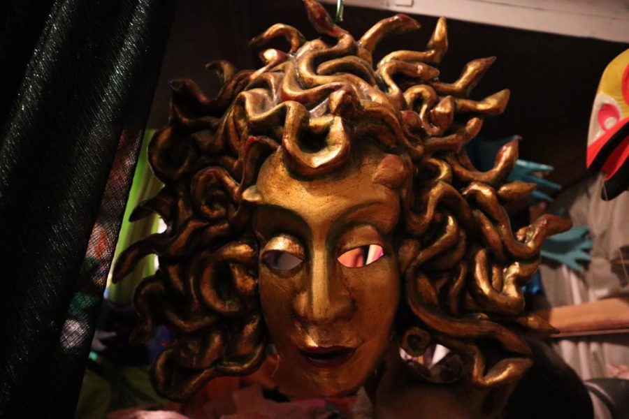 A medusa mask hangs from a beam inside the library. Artist Sara Peattie has collected thousands of puppets, from 10-foot tall giraffes to dragons.