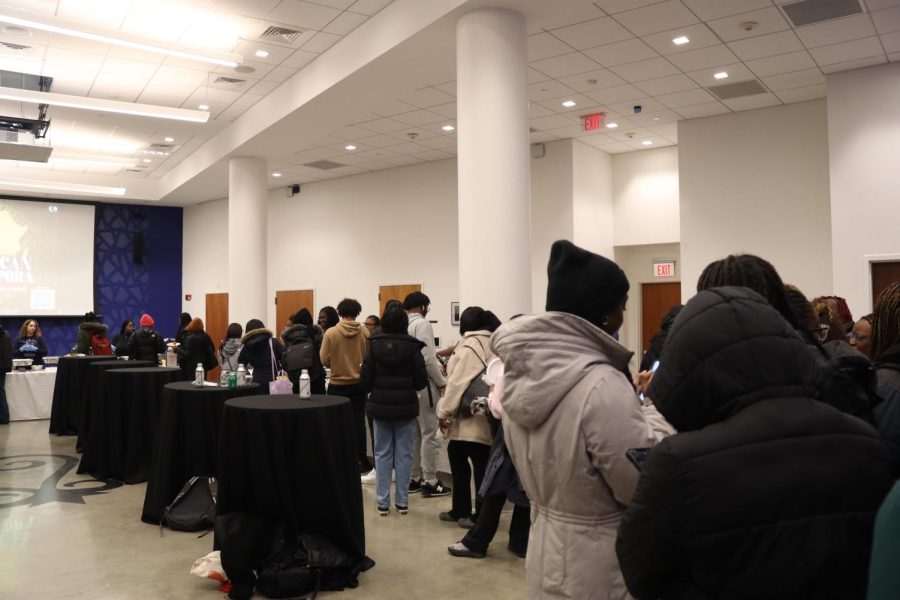 A line of students eagerly waits for a plate of food. The line extended outside the John D O’Bryant African American Institute and showed the immense popularity of the event.