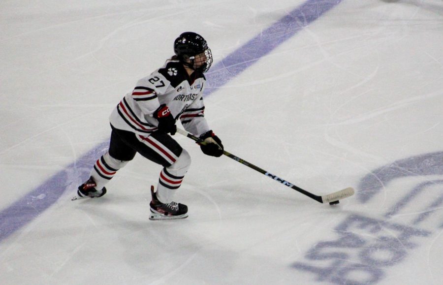 Northeastern senior defenseman Megan Carter races the puck up the ice. Carter notched 55 blocks this season and was named to Hockey Easts First Team.
