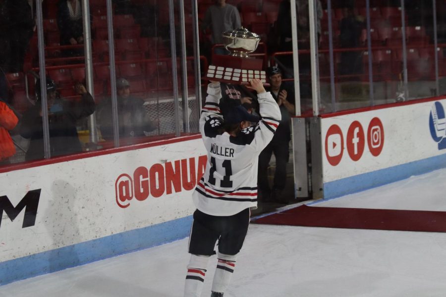 Müller hoists the Hockey East tournament trophy over her head. Saturdays championship victory was the sixth straight Northeastern victory in the tournament. 
