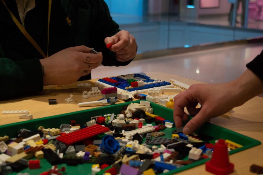 Two visitors craft their own Lego creations  on the third floor. Sawaya hoped that patrons would be inspired by the work in the exhibit and unleash their own creativity.