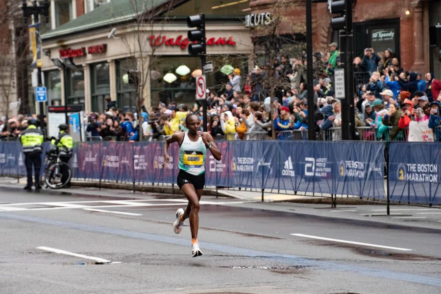 Hellen Obiri runs past cheering spectators on Boylston Street in the final stretch of the marathon. Obiri’s win marked her second ever marathon run, following the New York City Marathon last November.