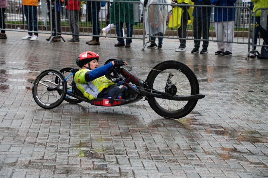 Zachary Stinson cycles in the rain near the 25 mile marker. Stinson finished first in the men’s handcycle division, beating second place Kevin Hillary by seven seconds.