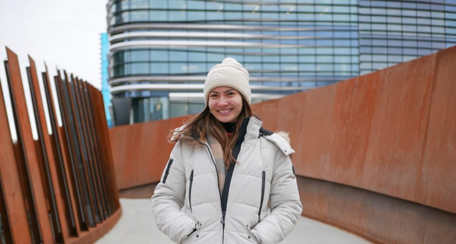 Breanna McClarey stands on the ISEC Bridge for a portrait. McClarey gained thousands of followers on TikTok and posts Northeastern-centered content.  