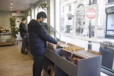 Customers look through records at Music Research Library in Beacon Hill. Co-founders Kochura and Warf relocated the store to Boston after operating for seven years in Providence.
