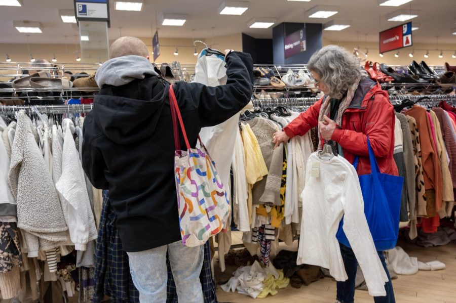  Customers pull clothes off of racks at a Goodwill in Jamaica Plain. As thrifting became more popular during the pandemic, people have wondered if the demand has increased prices and lowered accessibility to affordable clothing.