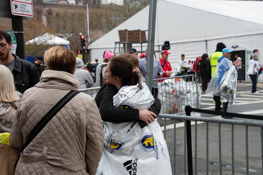 A runner receives a hug after completing the Boston Marathon. The 26.2 mile track stretches through eastern Massachusetts from Hopkinton to Boston. 