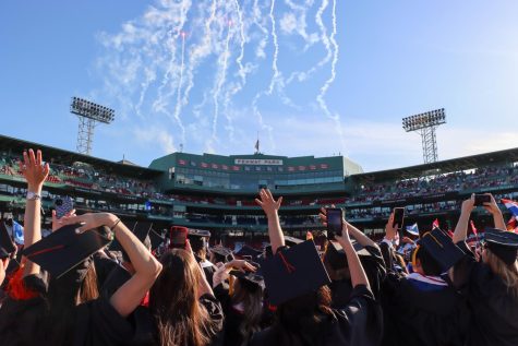 Northeastern graduates celebrate as fireworks explode above Fenway Park. The stadium held over 4,600 graduates during this years ceremony.