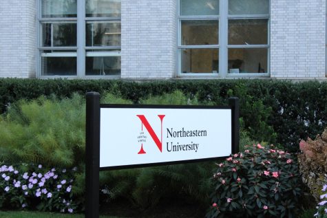 A white Northeastern University sign in front of a building. According to a 2022 report, 86.7% of respondents indicated they did not report Title IX-protected offenses to NUPD, the Title IX Office or a local police department. 
