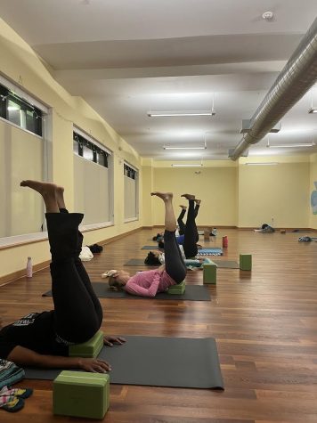 Members of 4 Corners Yoga + Wellness partake in a yoga class. The studio has offered more accessible and inclusive classes in Dorchester for years, but has decided to transition to an all-virtual format. Photo courtesy 4 Corners Yoga + Wellness.
