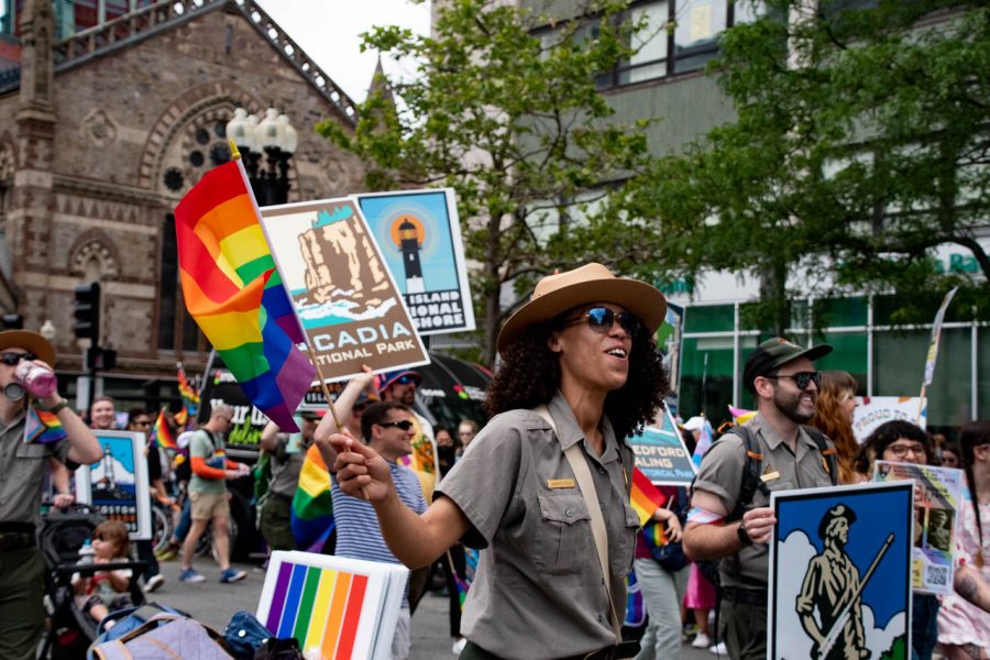 A National Park Service member waves a pride flag. The National Park Service preserves and dedicates several places to LGBTQ+ heritage, including Boston’s National Historical Park.