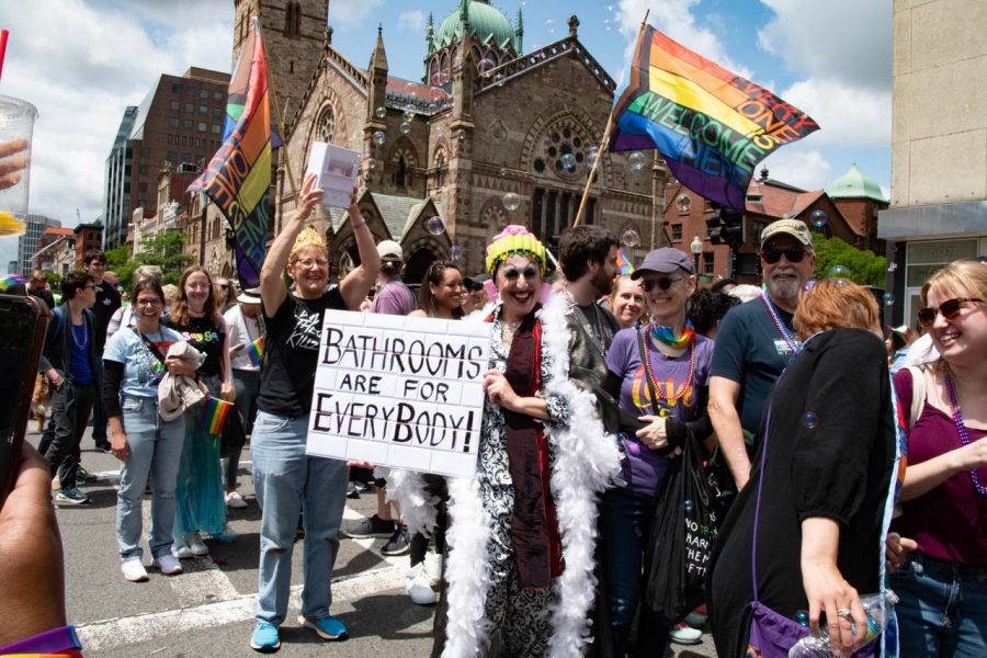 A person holds a sign that says, “Bathrooms are for Everybody!” Boston’s Pride Parade happened against the backdrop of multiple states passing anti-trans legislation.