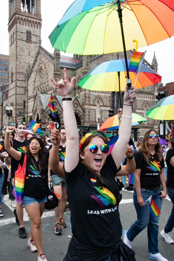 A participant yells in excitement while holding up a rainbow umbrella. After a three-year hiatus due to COVID-19, people filled the streets with excitement for Pride June 11.