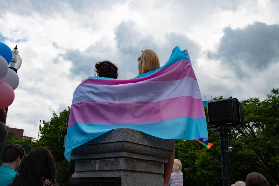 Two people watch the parade while draped in a trans pride flag at Boston Common. Massachusetts is considered one of the most LGBTQ+ friendly states, having received the ranking of “Working Toward Innovative Equality” by the Human Rights Campaign.