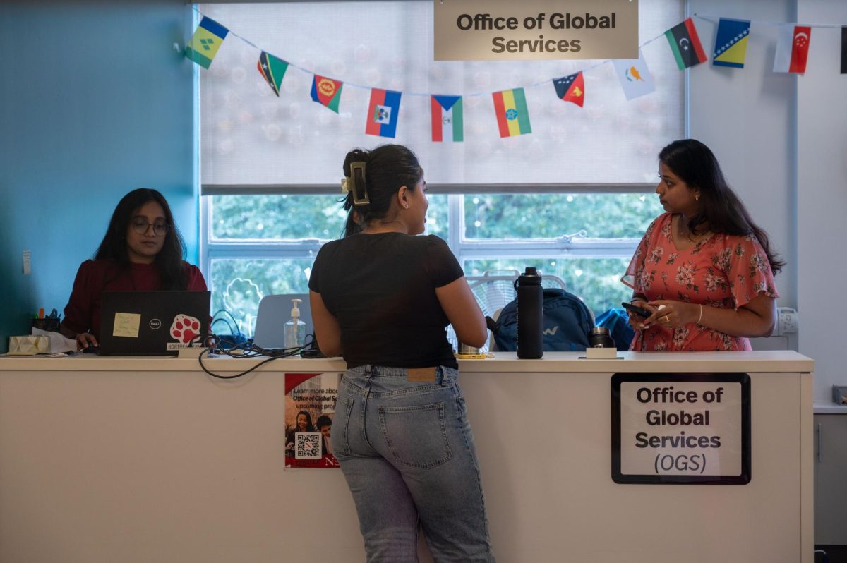 A student receives assistance at the Office of Global Services desk. Northeastern created the Office of Global Services to streamline academics and the immigration process for international students.