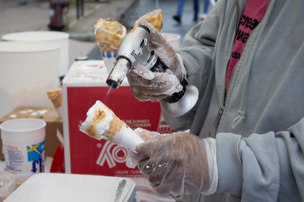 At Gracie’s Ice Cream booth, employees use a hand-held blow torch to singe the marshmallow Fluff on an ice cream cone before handing it to customers. It was a festival-favorite dessert and long lines formed just to try a cone.