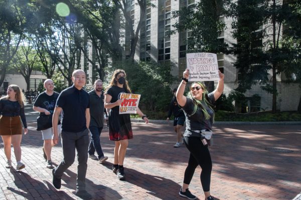Students hold signs promoting the union vote. Graduate students were seeking increased wage and benefits in response to Bostons rising cost of living.