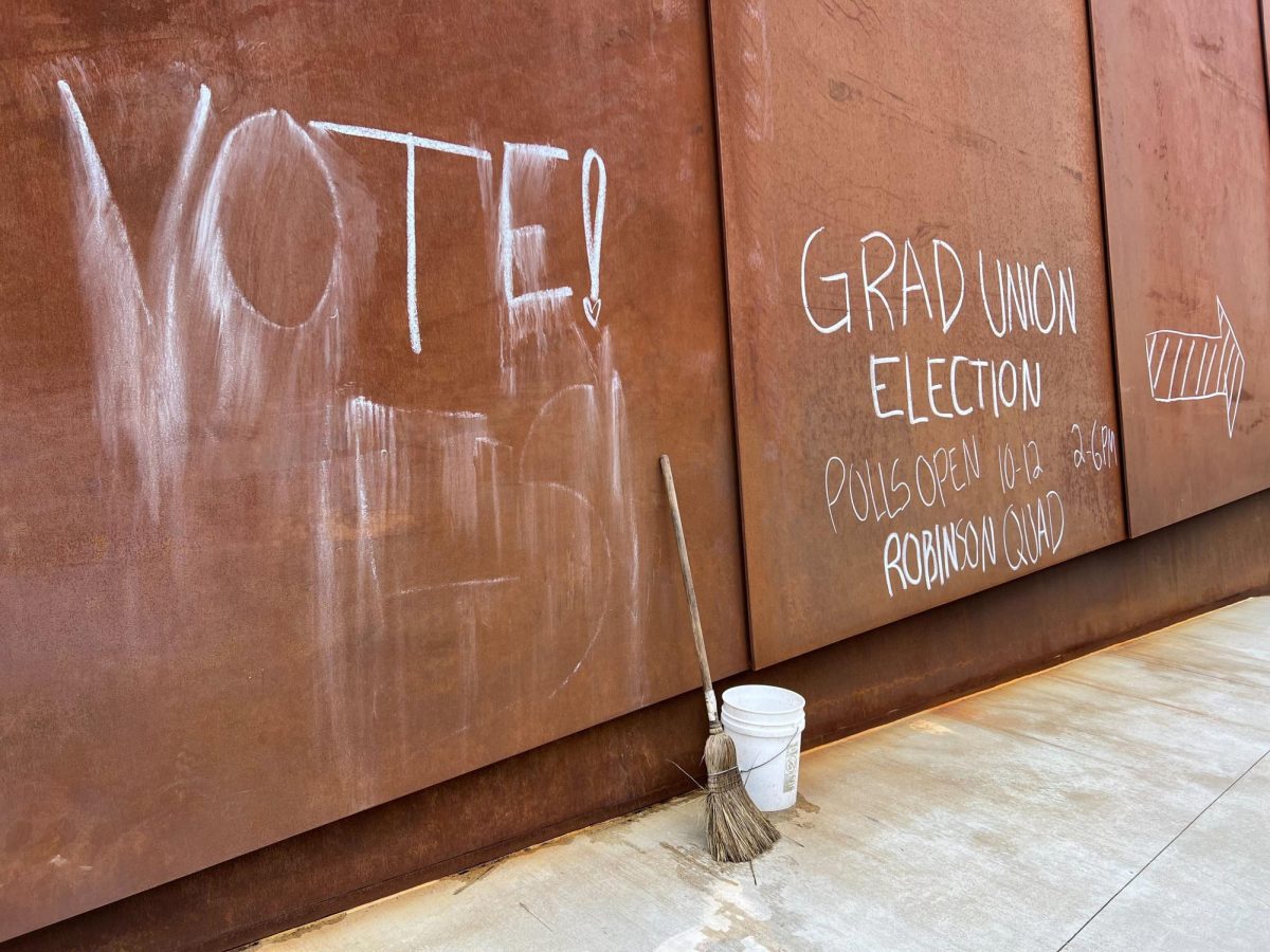 Messages appear on the ISEC bridge directing graduate workers towards the Robinson Quad, where voting occurs this week. The vote, years in the making, will determine whether graduate workers will be represented by a union. 