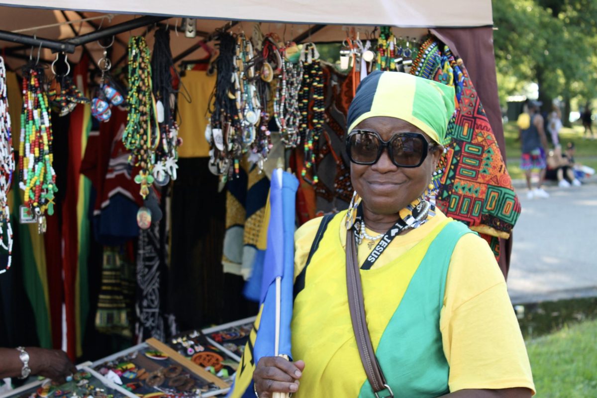Dee Green, a vendor at the Carnival, poses for a portrait. She and her family traveled from New York and sold jewelry, flags and other accessories as she celebrated her home country of Jamaica at Carnival. “We came here to have a wonderful day, and I’m glad that nothing changed and that they’re still out there having fun,” Green said.