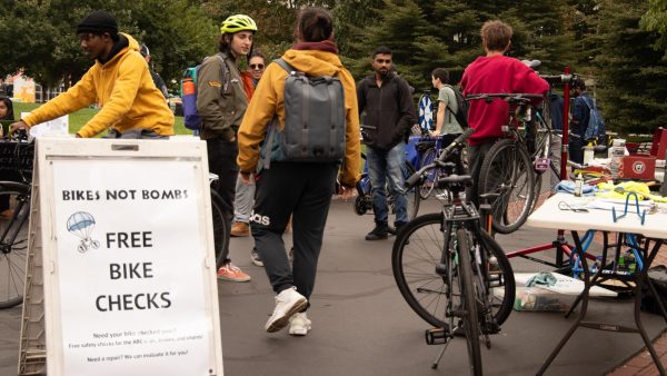 Students engage with each other as they wait for their bikes to get checked by Bikes Not Bombs. Bikes Not Bombs provided free bike safety checks for Northeastern students throughout the fair.