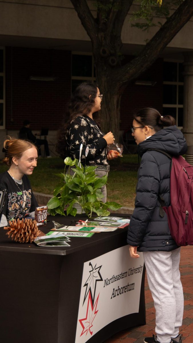 A Northeastern student speaks with a member of the university’s arboretum team. The Northeastern Arboretum assisted in sustainability efforts by educating students on the importance of sustainability through their greenspace and different plants around campus.