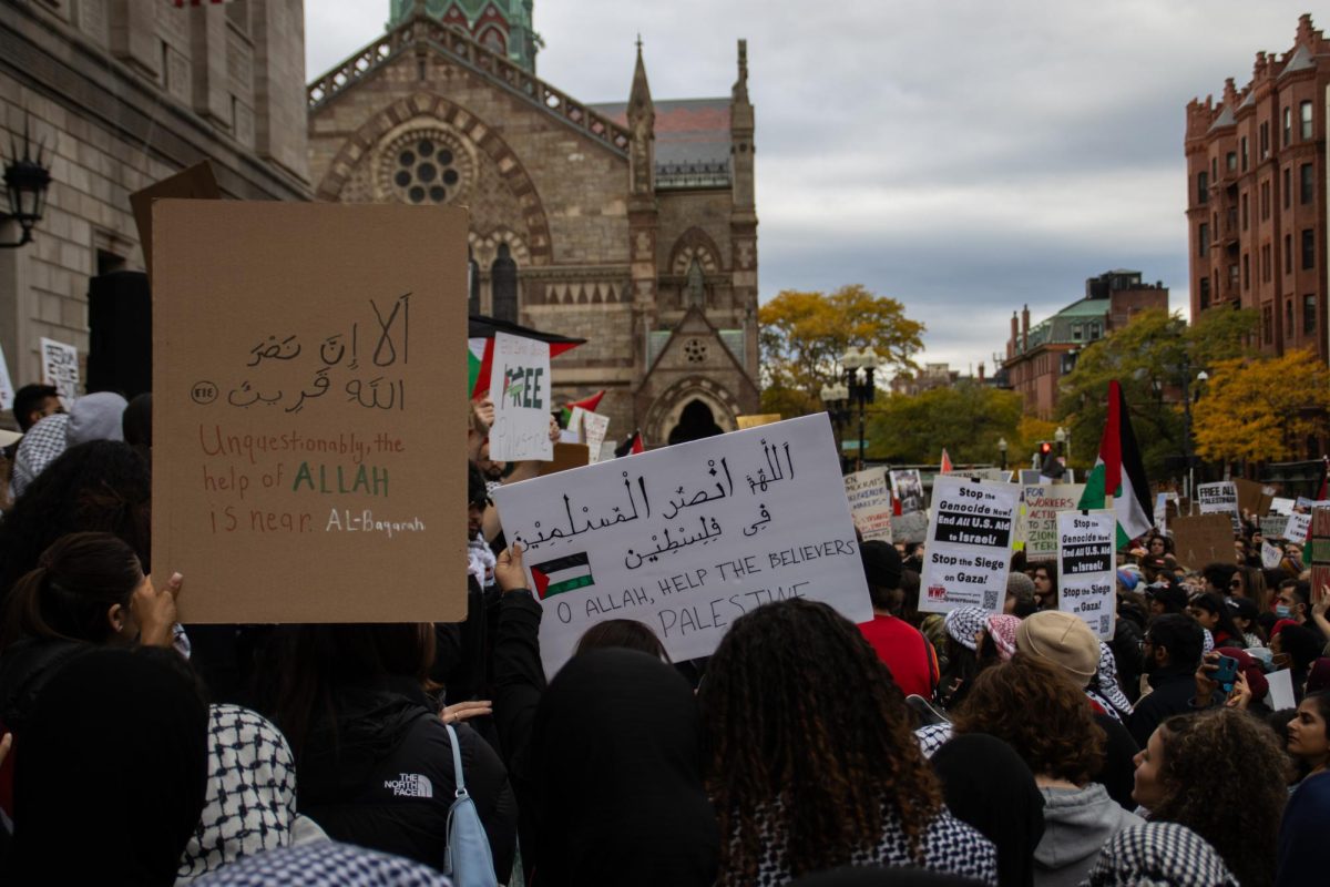 Protestors hold up signs with slogans in English and Arabic. Several chants throughout the day were conducted in both languages, and some speakers made parts of their remarks in Arabic as well.
