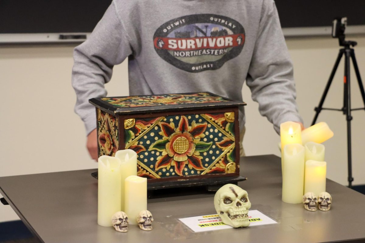 Manzi stands over the voting box during the first tribal of the season. Survivor: Northeastern was founded in the spring of 2017.