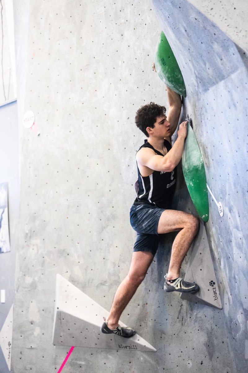 Zev Schwab, a third-year mechanical engineering major, competes in bouldering at the 2023 national competition. The team ranked ninth overall in both bouldering and lead climbing. Photo courtesy Northeastern Climbing Team.