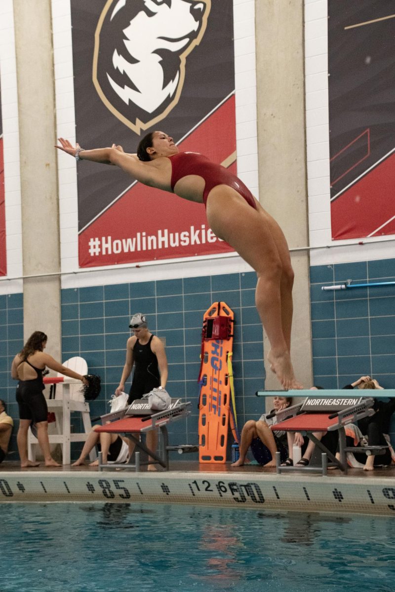 Junior diver Erin Murphy arches back for a backward dive on the 1-meter board. Murphy received the 2023 CAA Women’s Diver of the Year award. 