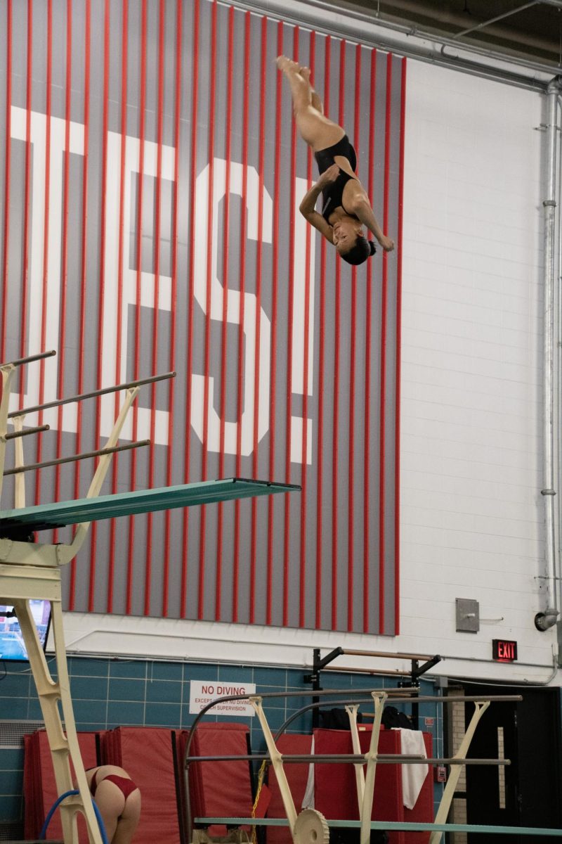  Jodi Au, a sophomore diver, performs a twisting dive off the 3-meter board. Au achieved her personal-best in the 3-meter dive, a 262.55, at the Boston Winter Open in February 2023. 