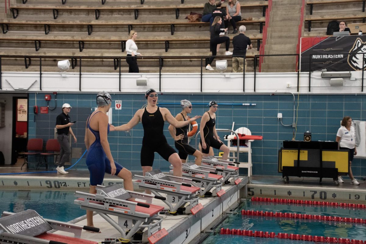 Peterson rallies her teams support before competing in the 100-yard freestyle. Peterson achieved a career-best time of 1:07.14 in the women’s 100-yard IM at a meet against the Massachusetts Institute of Technology Oct. 22, 2022. 
