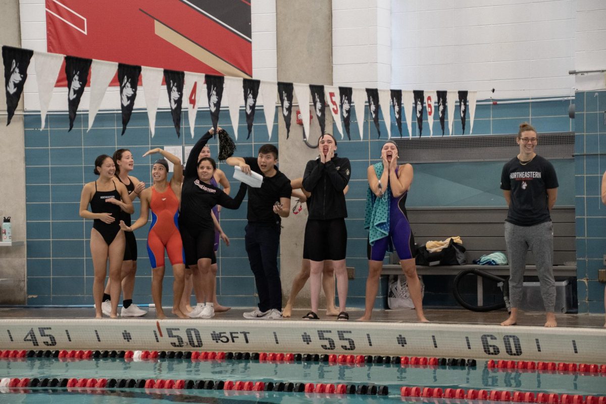 The black squad spells the word “black” with their arms during a chant. Alumni and team members were split into two squads to compete at the intrasquad meet.