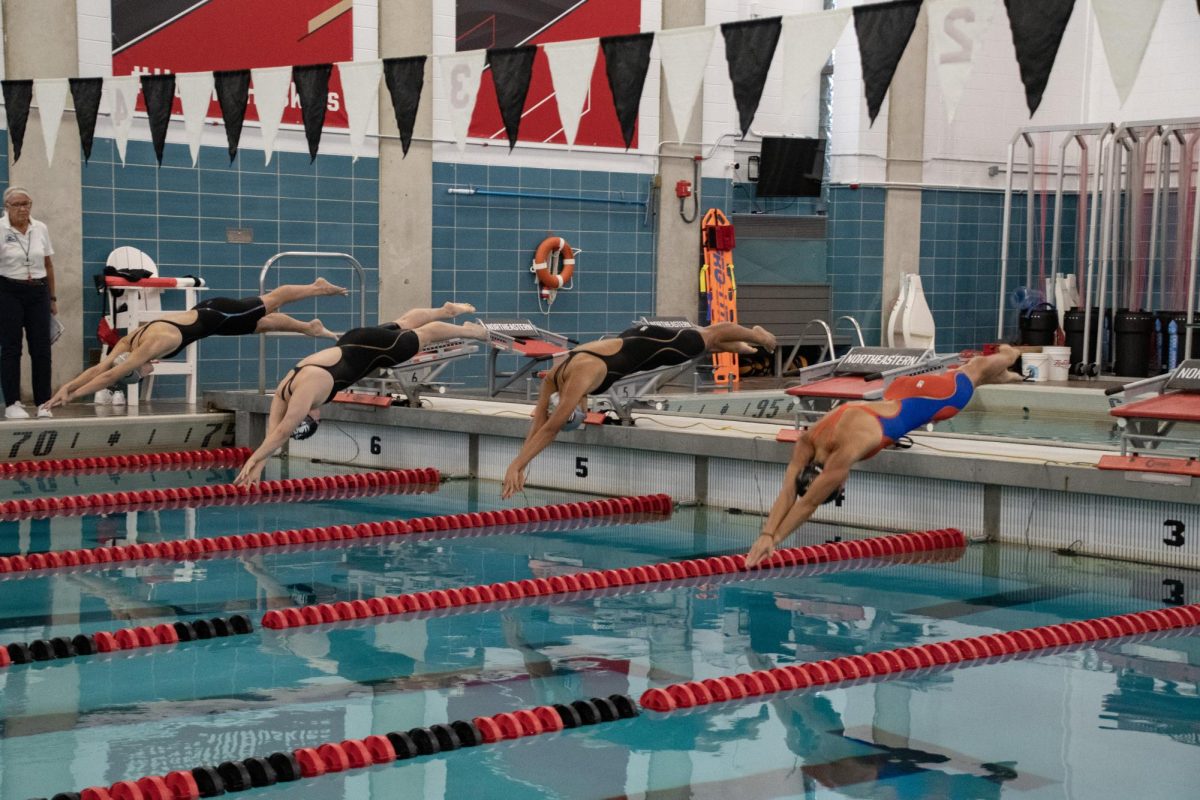 (Right to left) Kotoko Blair, a sophomore freestyle swimmer, Francesca Arciniegas, a junior butterfly/IM swimmer, Lena Wang, a senior breaststroke swimmer and Anna Verlander, a sophomore backstroke/freestyle swimmer, dive into the 100-yard IM. While swimming the IM, they performed four separate styles; backstroke, butterfly, freestyle and breaststroke.

