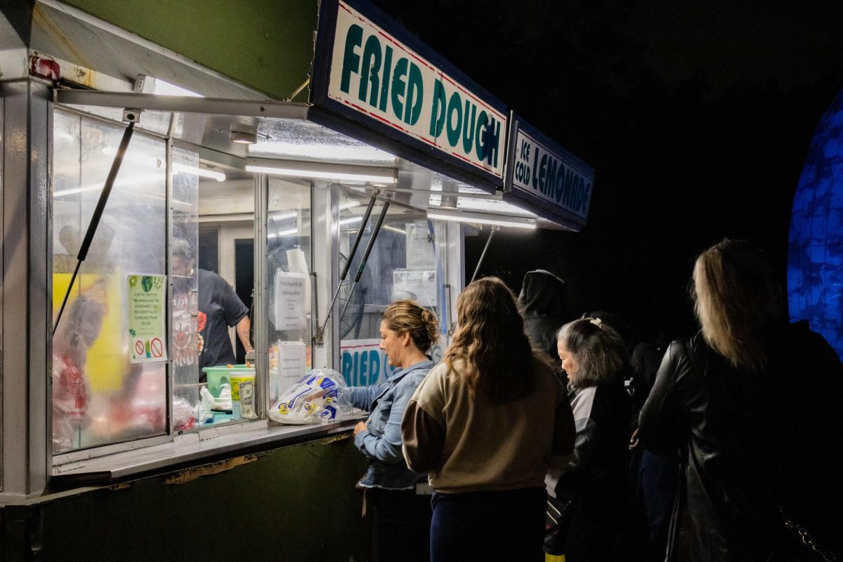 After walking around the zoo, visitors stop for a fried dough snack. A clearing at the entrance and exit of Boston Lights contained food vendors selling empanadas, lemonade and warm cider.